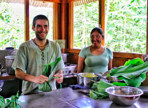A traveler learns to cook a local dish with one a local guide from Nuevo Eden