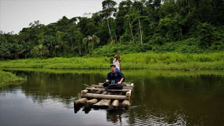 Traveler on a balsa raft in Machu Wasi lake in Salvacion