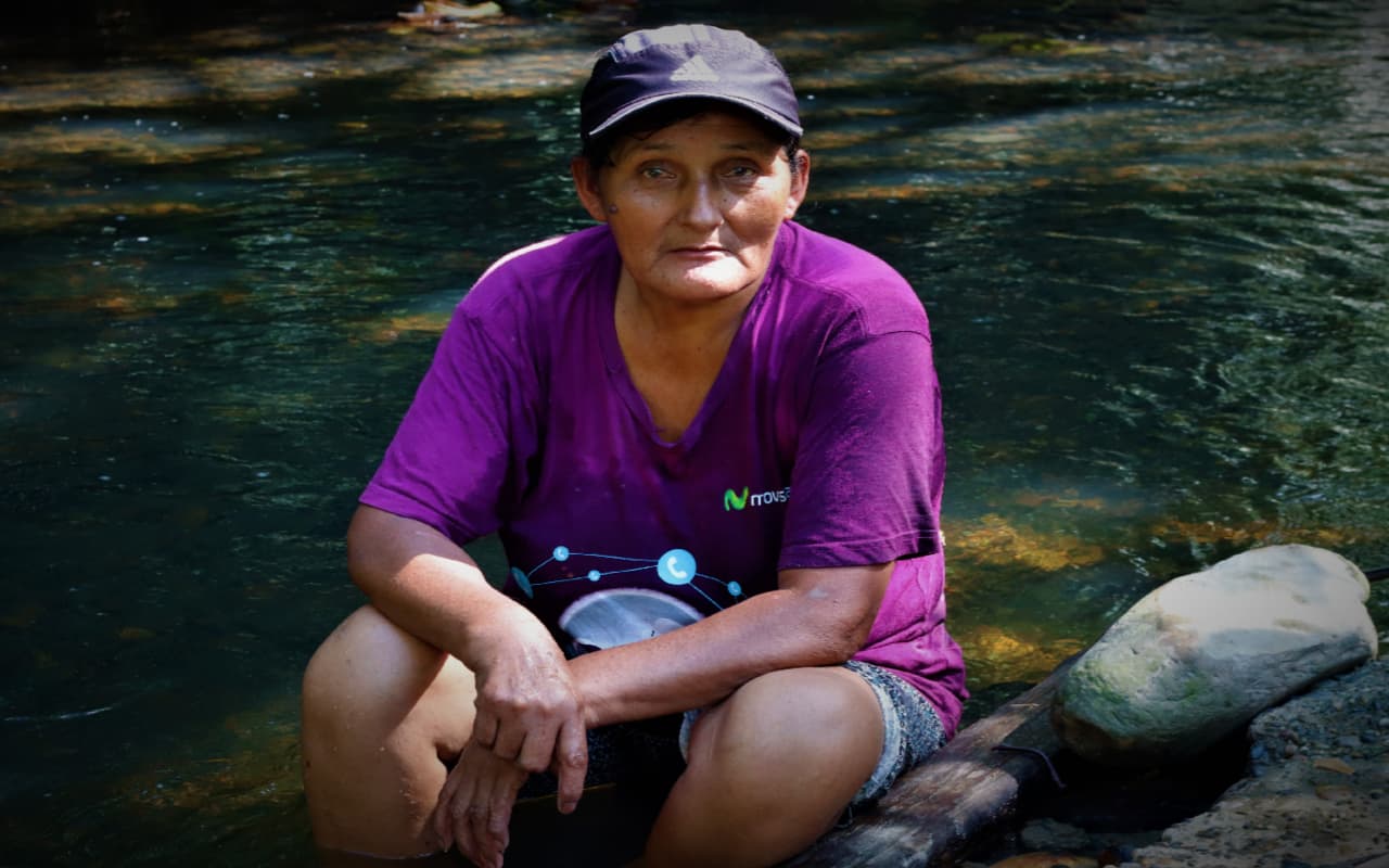 Family member, Mama Placida, sitting in the Tigre Mayo River in Nuevo Eden