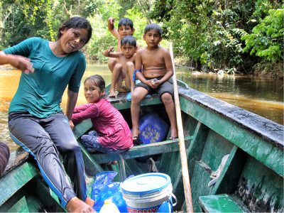 Children enjoy a boat ride in the jungle in the Amazon